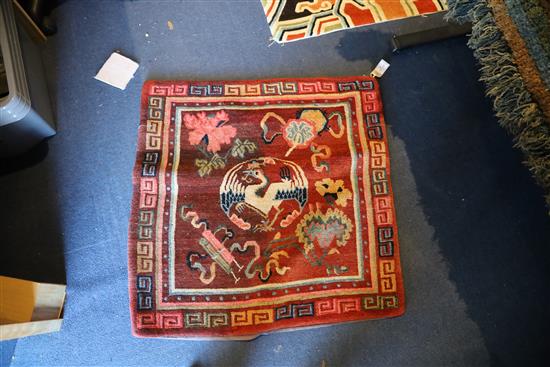 A Tibetan square sitting rug, late 19th/early 20th century, 80cm x 80cm